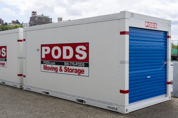two PODS moving containers sit on a residential street