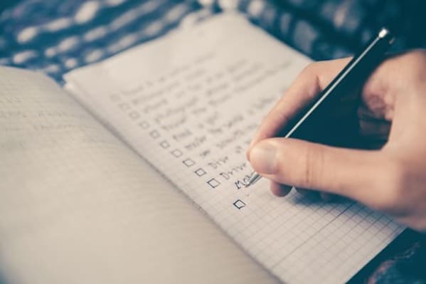 An open notebook with a checklist of items written