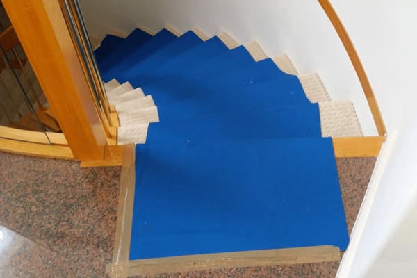 blue floor runner in place on wood floors and stairs
