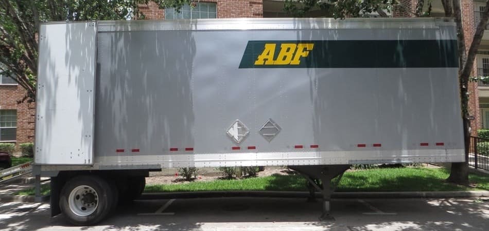 An ABF U-Pack trailer is parked on the road