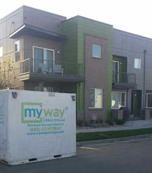 A MyWay Storage container parked outside of a home on the street