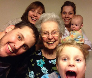 A large family, including a grandma and two grandkids, pose for a photo