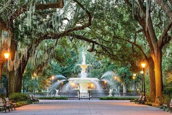 a park with trees and a large water fountain in Savannah Georgia