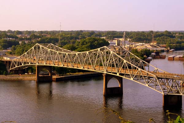 an old metal bridge spans a river in the Shoals Alabama