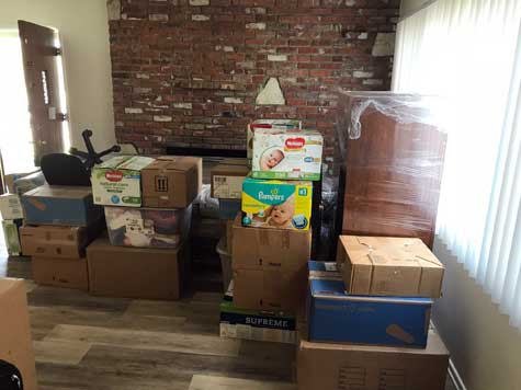 Living room with moving boxes packed and ready for movers
