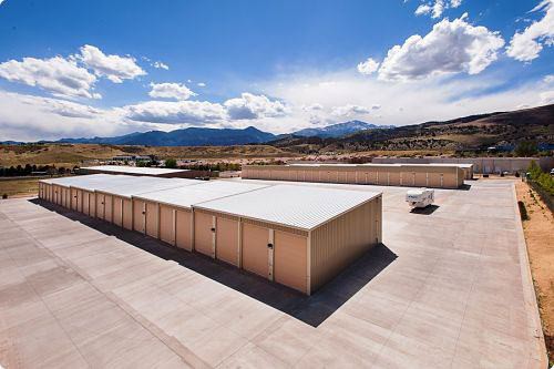 a self-storage facility surrounded by a brown landscape and hills