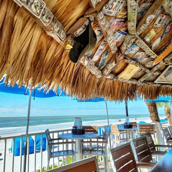 An exterior shot of the Mangos Tiki Bar overlooking the beach