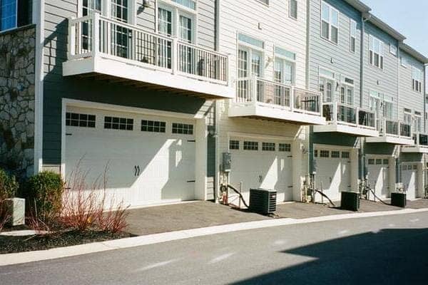 a row of townhouses that each have a balcony and garage