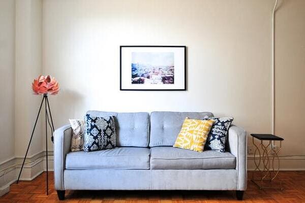 a light grey couch in an empty living room
